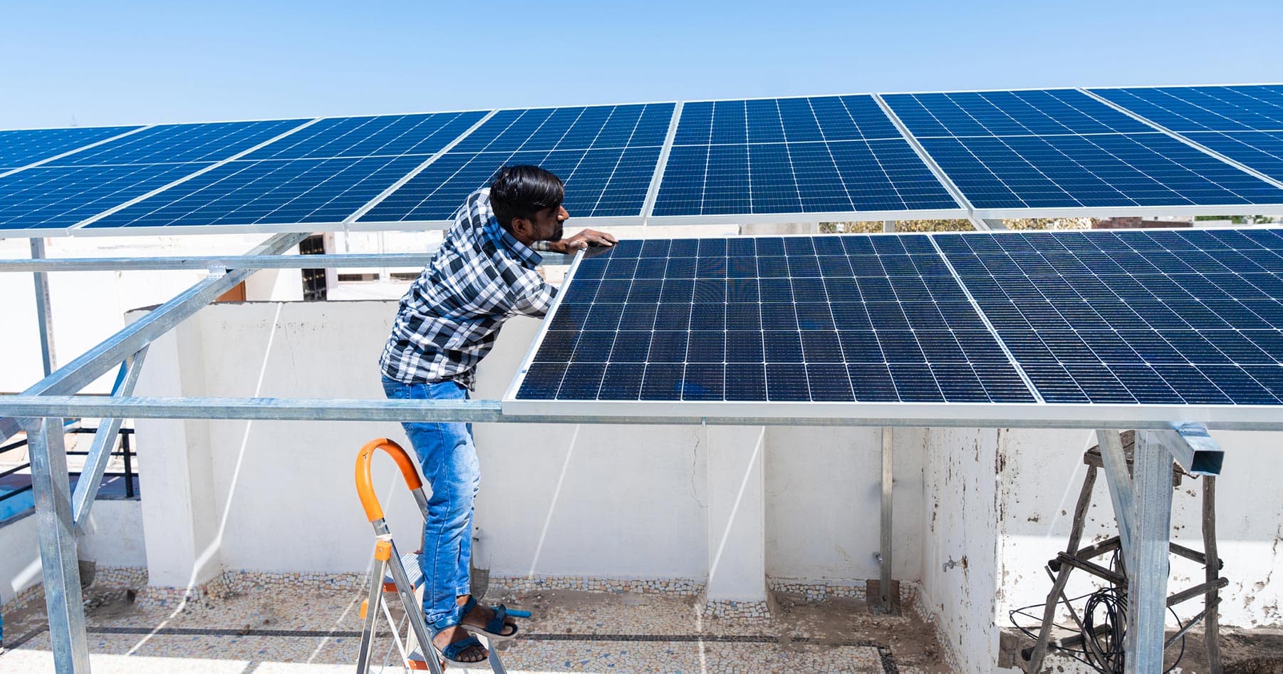 Technician adjusting rooftop solar panels